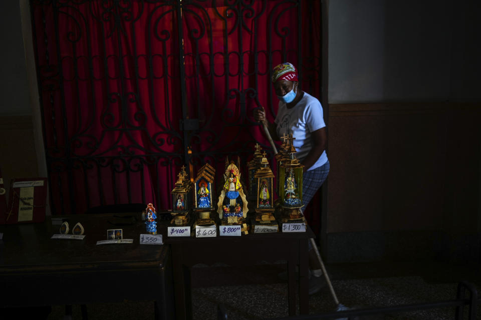 Statuettes of the Virgin of Charity of Cobre are for sale inside her shrine in El Cobre, Cuba, Saturday, Feb. 10, 2024. The Vatican-recognized Virgin, venerated by Catholics and followers of Afro-Cuban Santeria traditions, is at the heart of Cuban identity, uniting compatriots from the Communist-run Caribbean island to those who were exiled or emigrated to the U.S. (AP Photo/Ramon Espinosa)