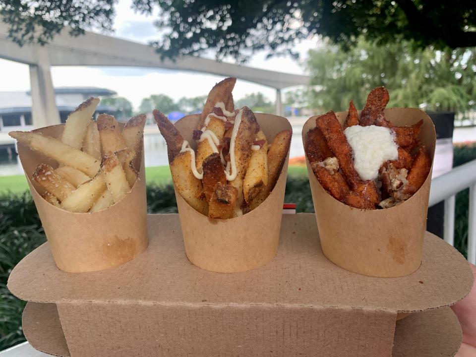 The fry flight from the Fry Basket kitchen at the EPCOT International Food & Wine Festival featured featured sea salt and malt vinegar fries, barbecued bacon fries with smoked aïoli and sweet potato casserole fries with candied pecans, toasted marshmallow cream and caramel whiskey.