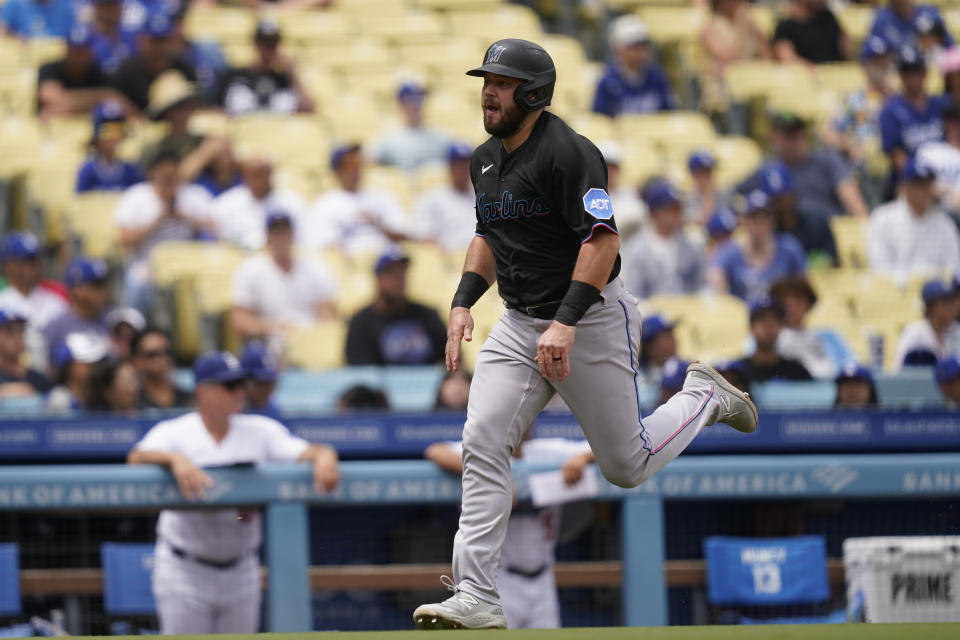 Miami Marlins' Jake Burger runs home to score off a double by Bryan De La Cruz during the fourth inning of the first baseball game of a doubleheader against the Los Angeles Dodgers, Saturday, Aug. 19, 2023, in Los Angeles. (AP Photo/Ryan Sun)