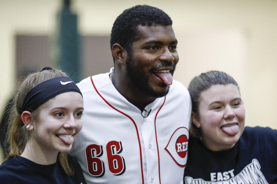 Cincinnati Reds Yasiel Puig poses for a photograph with young athletes during a media availability at the P&G MLB Cincinnati Reds Youth Academy, Wednesday, Jan. 30, 2019, in Cincinnati. (AP Photo/John Minchillo)