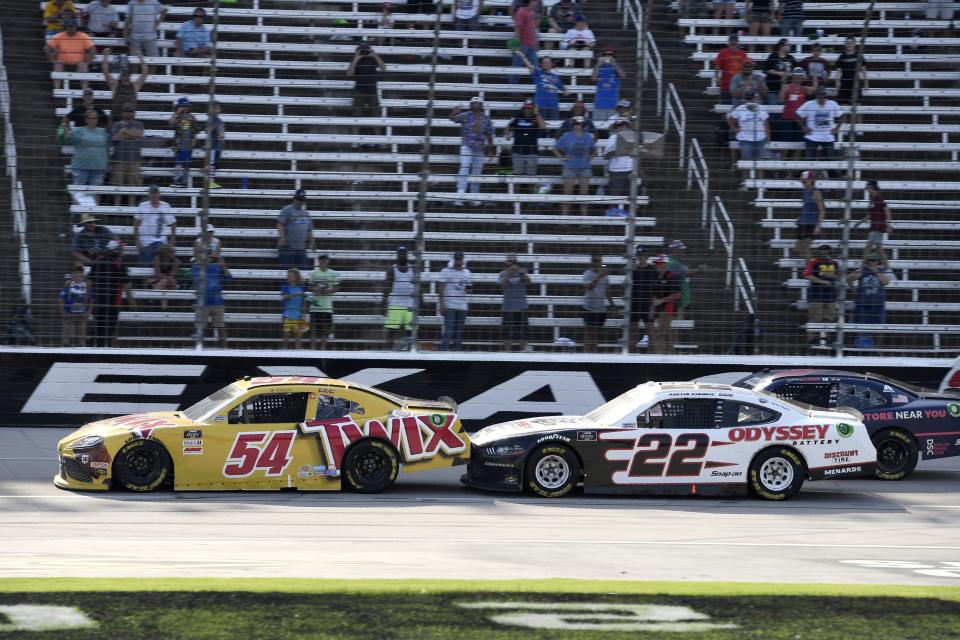 Kyle Busch (54) gets a push from Austin Cindric (22) on a restart with few laps to go in a NASCAR Xfinity Series auto race at Texas Motor Speedway in Fort Worth, Texas, Saturday, June 12, 2021. (AP Photo/Larry Papke)