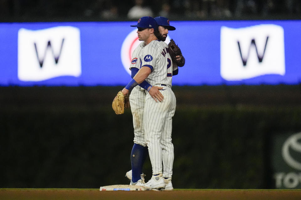 Chicago Cubs shortstop Dansby Swanson, left, and second baseman Nico Hoerner celebrate after their win over the Washington Nationals in a baseball game Thursday, Sept. 19, 2024, in Chicago. (AP Photo/Erin Hooley)