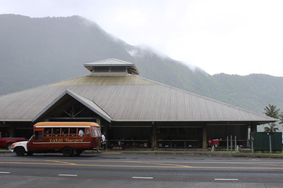 This Wednesday, March 4, 2020, photo shows a mini-bus in front of a public market place in the village of Fagatogo in Pago Pago, American Samoa. Mike Bloomberg spent more than $500 million to net one presidential primary win in the U.S. territory of American Samoa. His lone victory in the group of islands with a population of 55,000 was an unorthodox end to his much-hyped but short-lived campaign that ended Wednesday. (AP Photo/Fili Sagapolutele)
