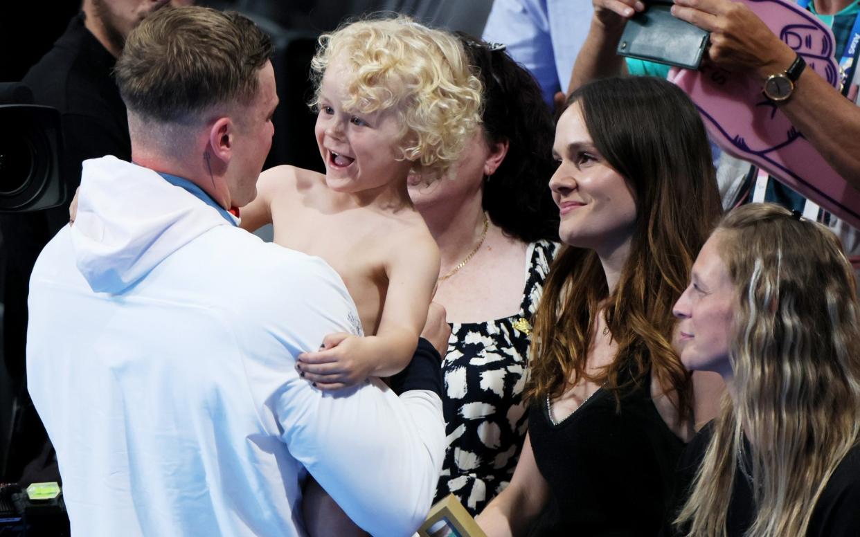 Peaty celebrated with his son and Ms Ramsay following the swimming medal ceremony at the Olympic Games in Paris