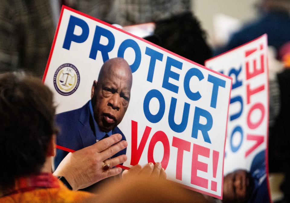 Protect or Vote signs are handed out during the Foot Soldiers Breakfast in Selma, Ala., on Saturday March 2, 2024.