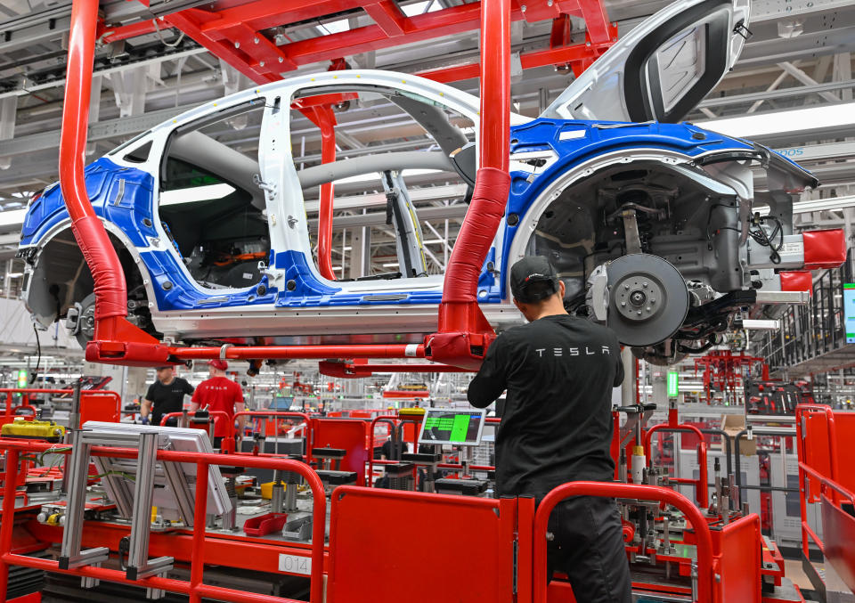 20 March 2023, Brandenburg, Grünheide: An employee of the Tesla Gigafactory Berlin Brandenburg works on a production line of a Model Y electric vehicle. The Tesla plant was opened and put into operation on March 22, 2022. In the meantime, about 10,000 people are employed there. Photo: Patrick Pleul/dpa (Photo by Patrick Pleul/picture alliance via Getty Images)