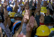 Anti-coup protesters flash a three-fingered sign of resistance during a demonstration in Yangon, Myanmar, Thursday, March 4, 2021. Demonstrators in Myanmar protesting last month's military coup returned to the streets Thursday, undaunted by the killing of scores of people the previous day by security forces. (AP Photo)