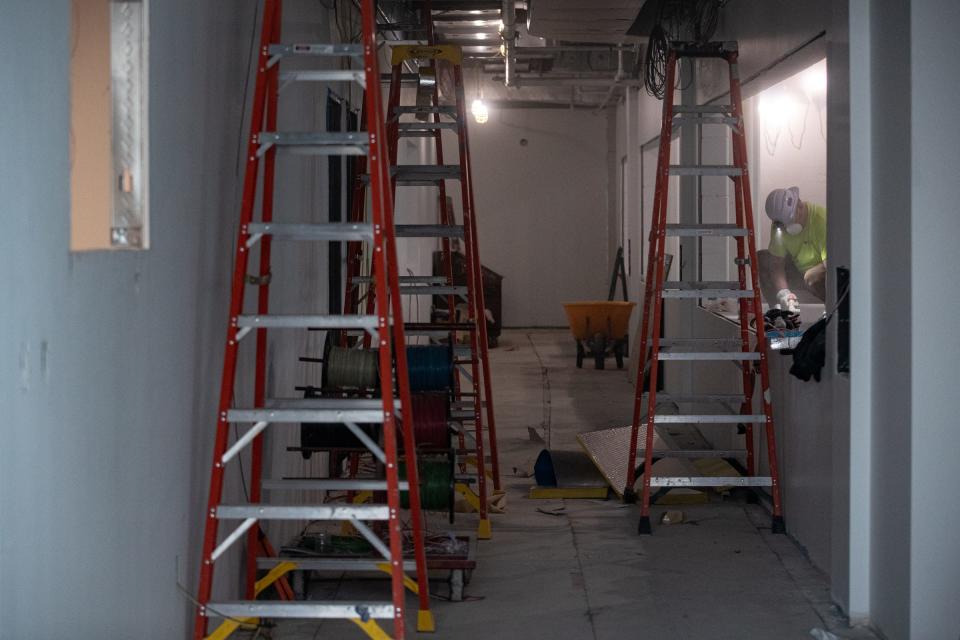 Construction workers prepare the tank stand in the sea turtle hospital at the Texas State Aquarium's new Port of Corpus Christi Center for Wildlife Rescue on Jan. 27, 2023, in Corpus Christi, Texas. Visitors will be able to view patients through large windows. The most common cause of a turtle beaching is entanglement, said Kara Hahn, projects and exhibits manager for the aquarium.