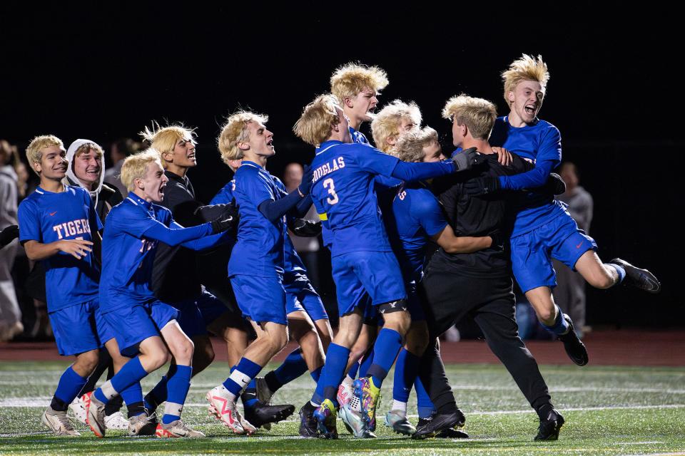 Douglas boys' soccer players rejoice after their victory over Bromfield in a Division 5 state semifinal.