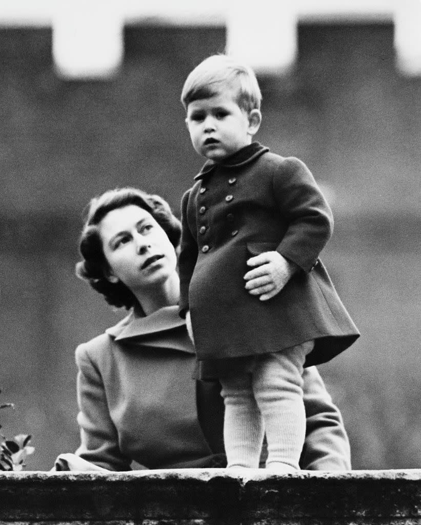 Elizabeth and a young Charles watch a procession, during the visit of Queen Juliana of the Netherlands, from the wall of Clarence House, in November 1950. (Getty Images)