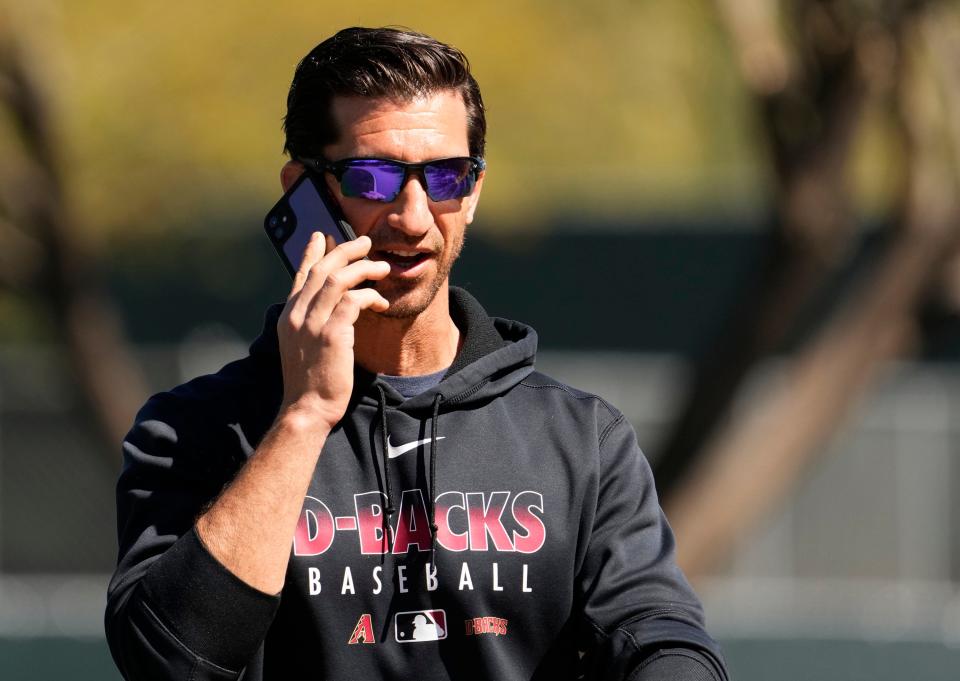 Mar 15, 2022; Scottsdale, Arizona, USA; Arizona Diamondbacks general manager Mike Hazen talks on his phone during spring training at Salt River Fields.