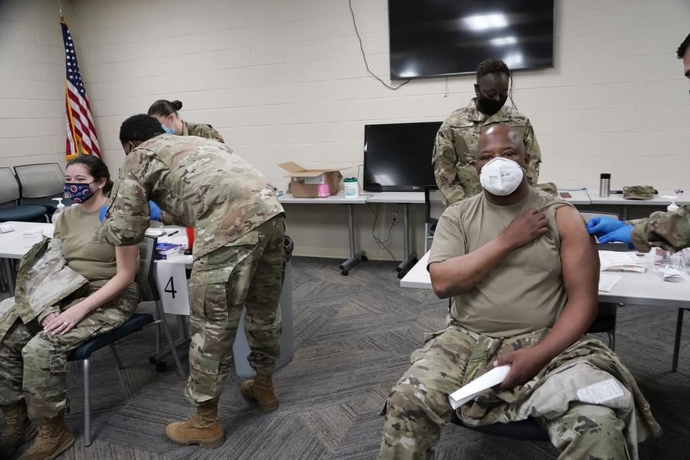 In this Dec. 23, 2020, file photo, members of the Mississippi Air and Army National Guard Guard receive the first dose of the Moderna COVID-19 vaccine in Flowood, Miss. (AP Photo/Rogelio V. Solis, File)