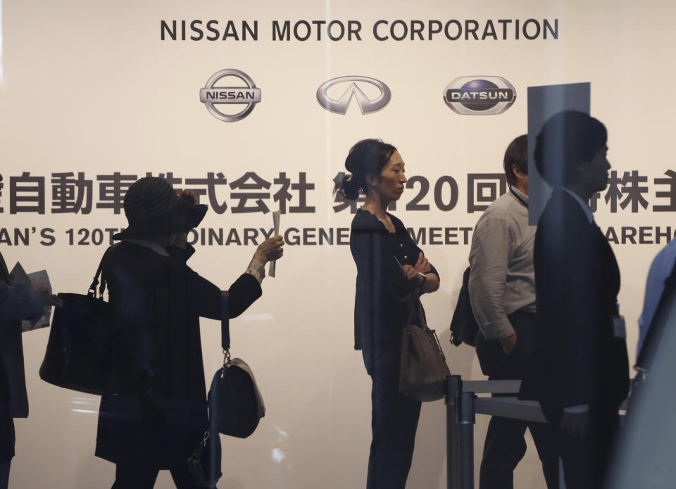 Shareholders arrive for Nissan's general meeting of shareholders in Yokohama, near Tokyo, Tuesday, June 25, 2019. Japanese automaker Nissan faces shareholders as profits and sales tumble after its former star chairman faces trial on financial misconduct allegations.(AP Photo/Koji Sasahara)
