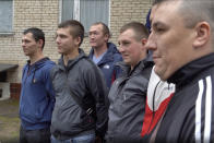 In this photo made from footage provided by the Russian Defense Ministry on Wednesday, July 15, 2020, a group of volunteers participating in a trial of a coronavirus vaccine pose for a photo as they leave the Budenko Main Military Hospital outside Moscow, Russia. Russia is boasting that it’s about to be the first country to approve a COVID-19 vaccine, but scientists worldwide are sounding the alarm that the headlong rush could backfire. (Russian Defense Ministry Press Service via AP)