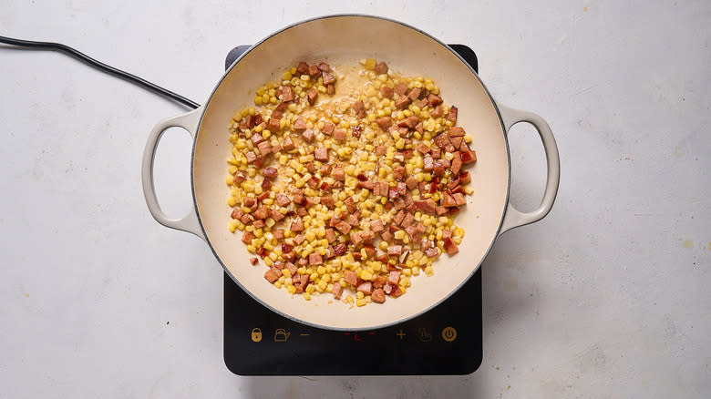 corn and sausage cooking in skillet