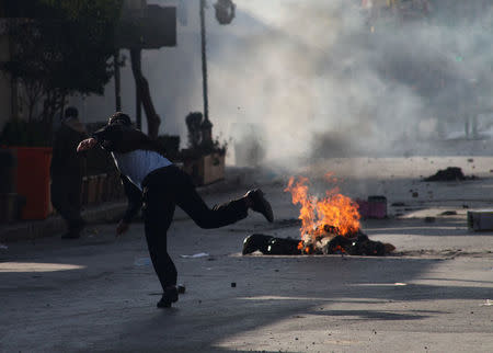 A Kurdish protester throughs stone during a rally against the Kurdistan Regional Government (KRG) in Sulaimaniyah, Iraq December 18, 2017. REUTERS/Stringer. NO RESALES. NO ARCHIVES