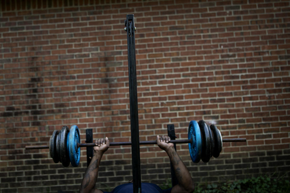 La Jarvis D. Love lifts weights at a makeshift outdoor gym down near his home in Senatobia, Miss., Sunday, June 9, 2019. Love says he works out to assuage memories of alleged sexual abuse. (AP Photo/Wong Maye-E)