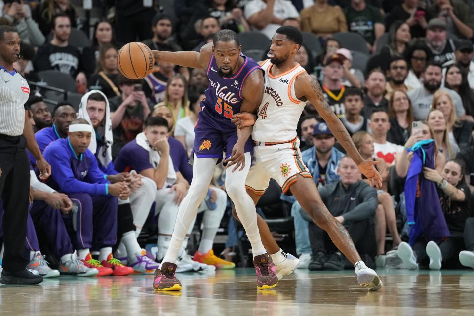 Phoenix Suns forward Kevin Durant (35) backs in against San Antonio Spurs guard Blake Wesley (14) in the first half at Frost Bank Center.