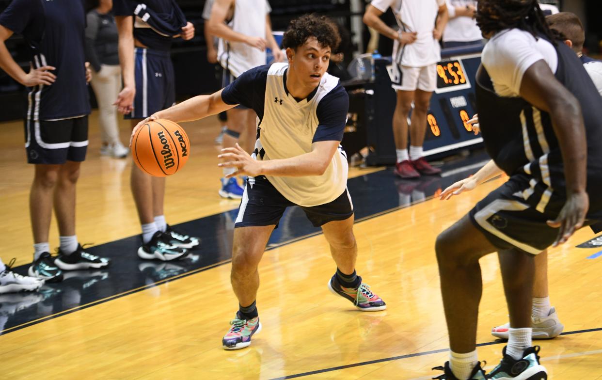 Monmouth guard Xander Rice works against defenders during Monmouth's first practice of the season on Tuesday at OceanFirst Bank Center in West Long Branch.