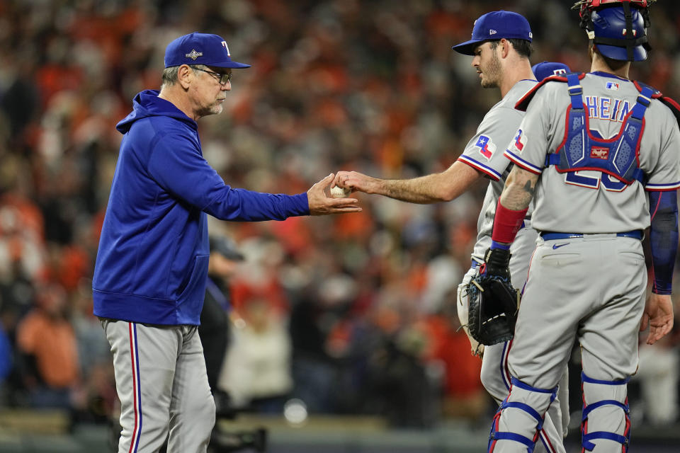 Texas Rangers manager Bruce Bochy, left, takes pitcher Cody Bradford out of the game during the eighth inning in Game 2 of an American League Division Series baseball game, Sunday, Oct. 8, 2023, in Baltimore. (AP Photo/Julio Cortez)