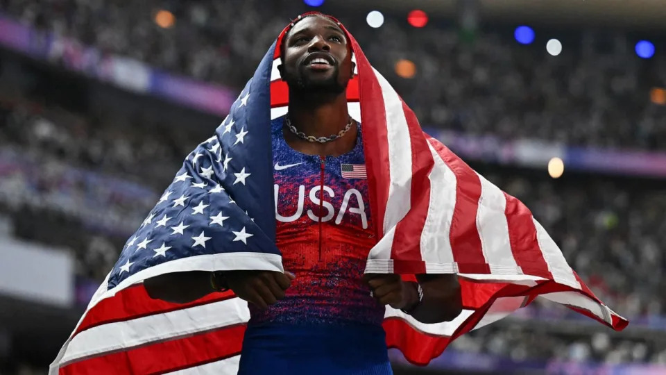 PHOTO: Noah Lyles of the U.S celebrates winning the gold medal in the men's 100m final at the 2024 Paris Olympic Games, Aug. 4, 2024. (Jewel Samad/AFP via Getty Images)