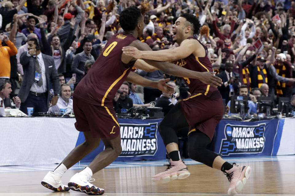 FILE - In this March 15, 2018, file photo, Loyola-Chicago guard Donte Ingram (0) and Marques Townes, right, celebrate their 64-62 win over Miami in a first-round game at the NCAA college basketball tournament in Dallas. Their run to the Final Four as an 11 seed never seemed short of drama.(AP Photo/Tony Gutierrez, File)