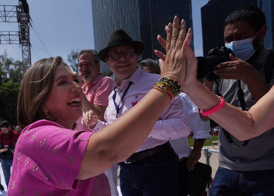 Senator Xóchitl Gálvez, opposition candidate for the presidential elections, high-fives a supporter during a political event at the Angel of Independence monument, in Mexico City, Sunday, Sept. 3, 2023. (AP Photo/Marco Ugarte)