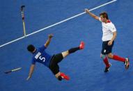 Argentina's Pedro Ibarra (L) flies through the air after clattering into Britain's Matthew Daly during their men's Group A hockey match at the London 2012 Olympic Games at the Riverbank Arena on the Olympic Park in London July 30, 2012.