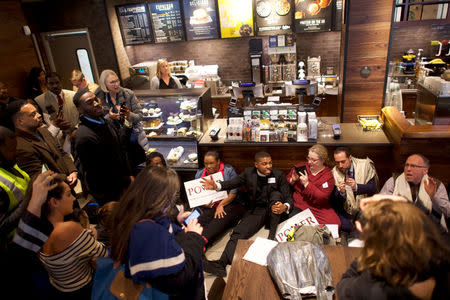 Interfaith clergy leaders stage a sit-in at the Center City Starbucks, where two black men were arrested, in Philadelphia, Pennsylvania U.S. April 16, 2018. REUTERS/Mark Makela