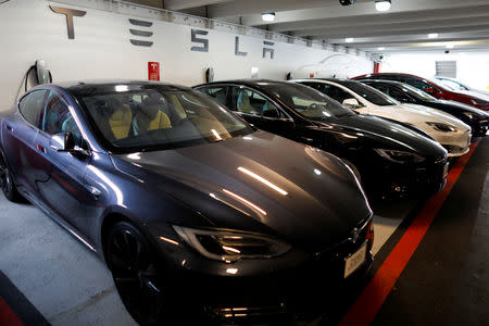 FILE PHOTO: Tesla Model 3 and X cars charging in an underground parking lot next to a Tesla store in San Diego, California, U.S., May 30, 2018. REUTERS/Mike Blake/File Photo