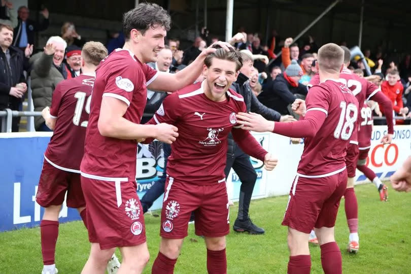 Two-goal hero Liam Scullion, centre, and the Clyde players celebrate at Elgin -Credit:Craig Black