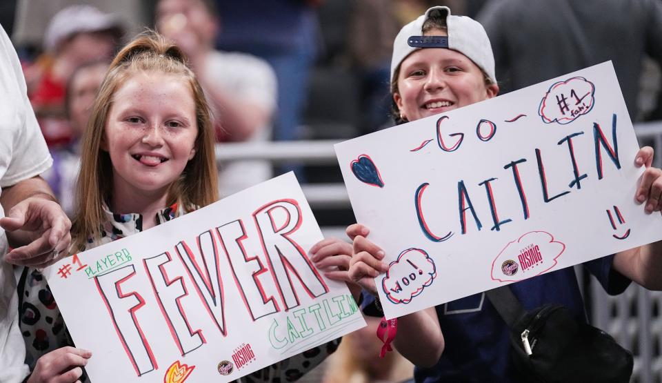Two young Indiana Fever fans hold up signs for Caitlin Clark before a preseason game last week.