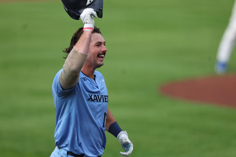 Xavier University's first baseman Luke Franzoni (13) celebrates with his teammates after a home run during their game against Creighton in the Big East Tournament, Friday, May 27, 2022.