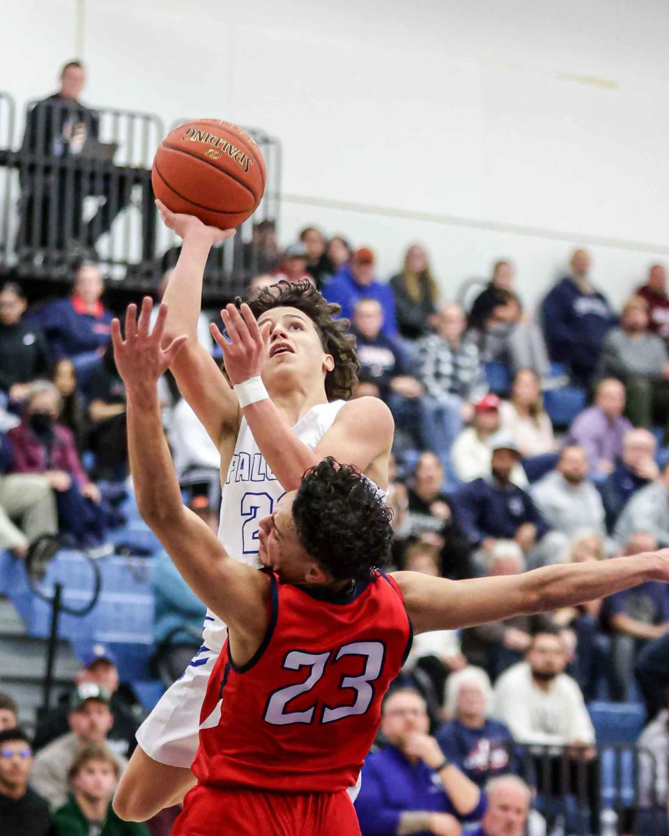 Leo Tirado (22) goes up for a lay-up as Marquis Ferreira (23) fouls him. Cedar Crest came back and was able to secure a victory over cross town rival Lebanon 55-48 in the Cage.