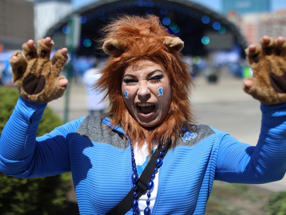 Erika Gonzalez, 41, of Detroit, shows her Lions' pride during the NFL Draft Experience in downtown Detroit on Friday, April 26, 2024.