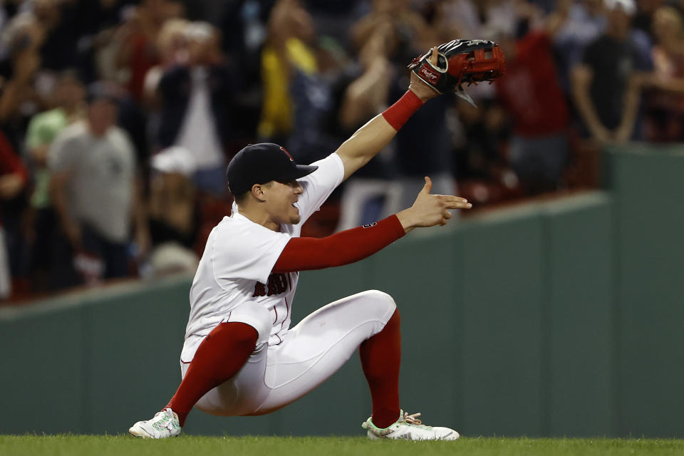 Boston Red Sox's Enrique Hernandez points to Hunter Renfroe, who had thrown out Tampa Bay Rays' Joey Wendle at third base for the final out in Boston's 2-1 win in a baseball game Wednesday, Sept. 8, 2021, at Fenway Park in Boston. (AP Photo/Winslow Townson)