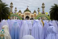 <b>PATTANI, THAILAND:</b> Thai Muslim women pray during the special Eid ul-Fitr morning prayer at the Central Mosque of Pattani in the southern province of Pattani, Thailand. The beautiful mosque is the largest in Thailand. Pattani is one of the four provinces of Thailand where the majority of the population (88%) are Malay Muslim.