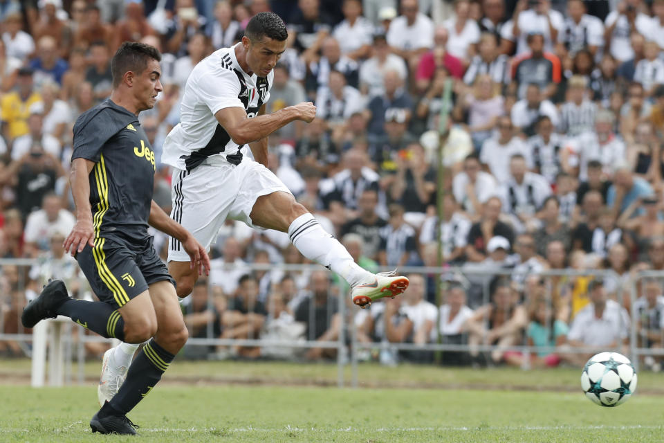 FILE - In this Sunday, Aug.12, 2018 filer, Juventus' Cristiano Ronaldo, right, controls the ball during a friendly match between the Juventus A and B teams, in Villar Perosa, northern Italy. The eyes of the footballing world will be on Verona where Cristiano Ronaldo is expected to make his Serie A debut when Chievo Verona hosts Juventus. Ronaldo has moved from Real Madrid to Juventus in a Serie A record 112 million-euro ($131.5 million) deal and is expected to make the Bianconeri even more dominant in Serie A. Carlo Ancelotti is back in Italian football after a nine-year absence and the new Napoli coach is keen to ensure that doesn’t happen. (AP Photo/Antonio Calanni, File )