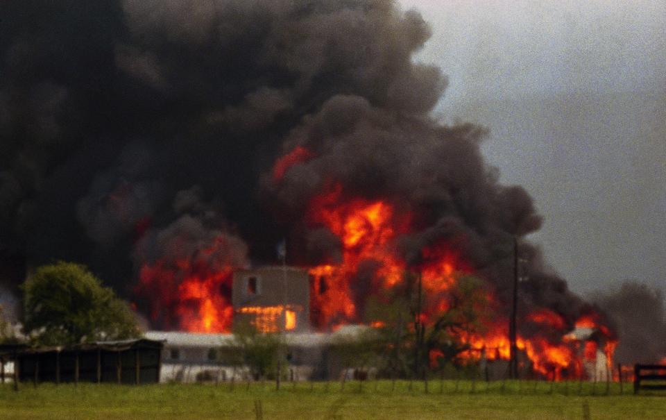 Fire engulfs the Branch Davidian compound near Waco, Texas on Monday, April 19, 1993. The compound burned to the ground after FBI agents in an armored vehicle smashed the buildings and pumped in tear gar. The Justice Department said cult members set the fire.