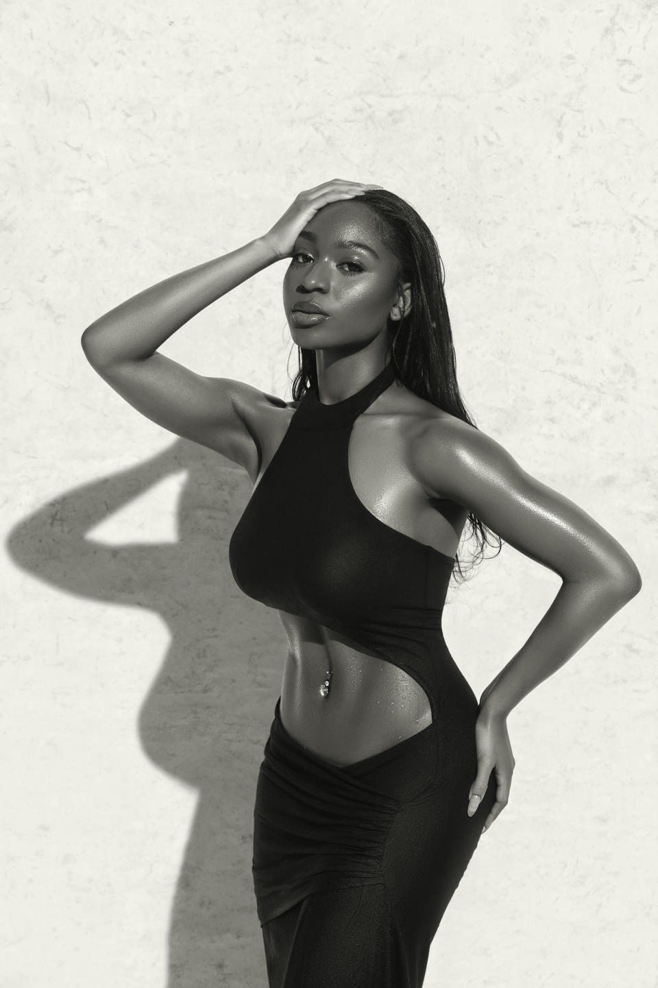 Normani poses for a black-and-white photo in a sexy gown that features her toned midsection. (Blair Caldwell)