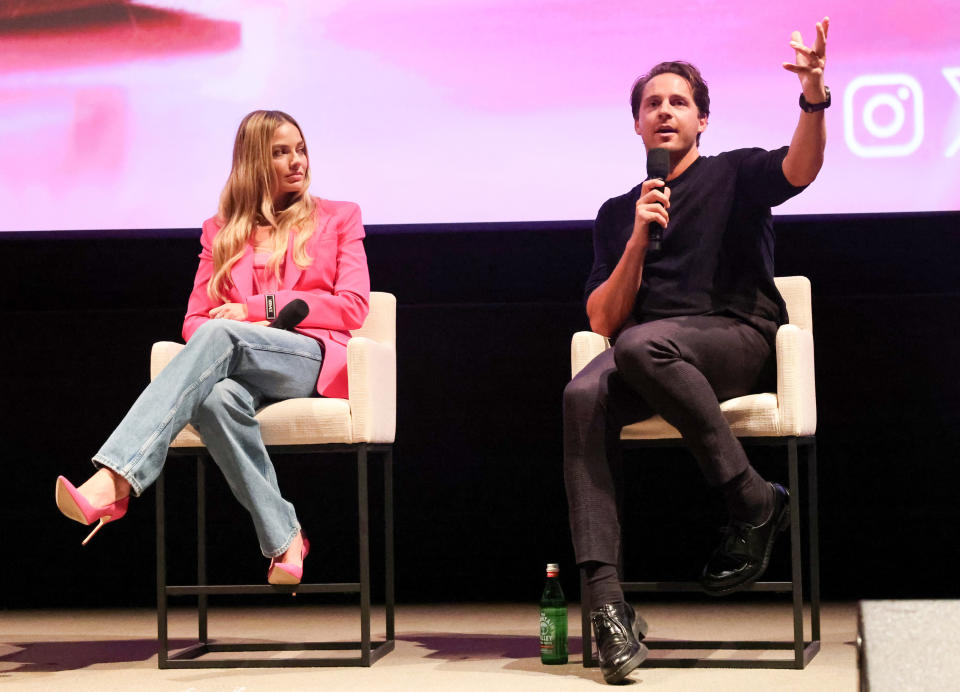 Margot Robbie and Tom Ackerley onstage