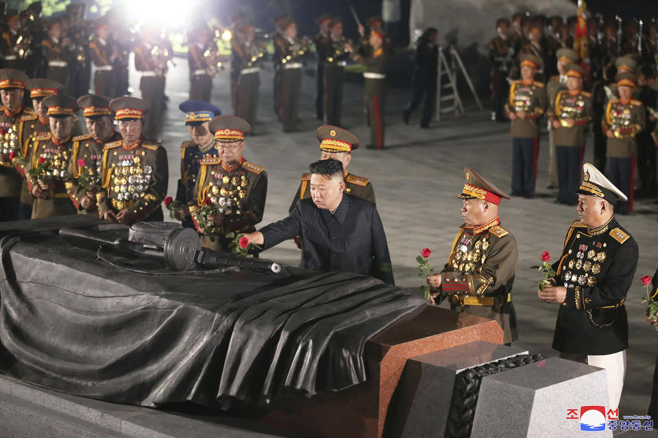 In this photo provided by the North Korean government, North Korean leader Kim Jong Un, front center, offers a flower at a liberation war martyrs cemetery in Pyongyang, North Korea, Tuesday, July 27, 2021 to mark the end of the Korean War. Independent journalists were not given access to cover the event depicted in this image distributed by the North Korean government. The content of this image is as provided and cannot be independently verified. Korean language watermark on image as provided by source reads: "KCNA" which is the abbreviation for Korean Central News Agency. (Korean Central News Agency/Korea News Service via AP)