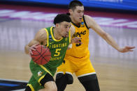 Oregon guard Chris Duarte (5) drives on Iowa guard CJ Fredrick during the second half of a men's college basketball game in the second round of the NCAA tournament at Bankers Life Fieldhouse in Indianapolis, Monday, March 22, 2021. (AP Photo/Paul Sancya)
