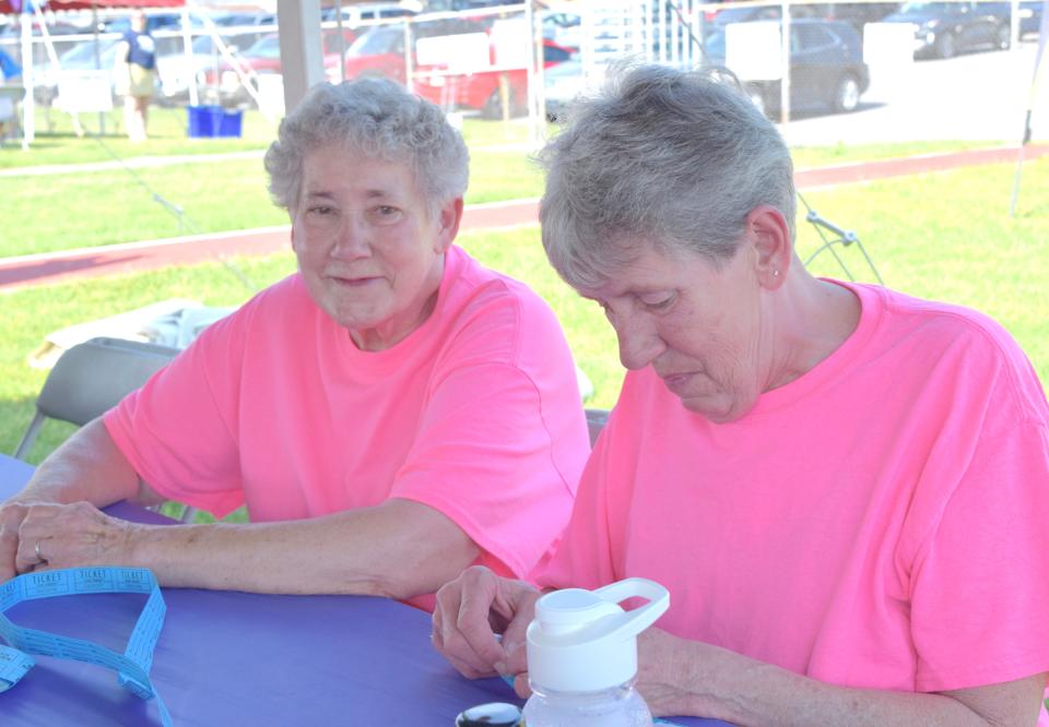 Sisters Arlene Barnes, left, and Cindy Quillen prepare for Saturday's Relay for Life in Greencastle, Pa.