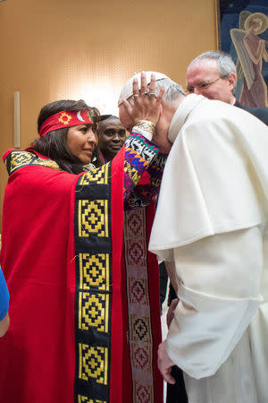 Pope Francis is greeted during a meeting with indigenous people to mark the 40th governing council of the the International Fund for Agricultural Development (IFAD) at the Vatican February 15, 2017. Osservatore Romano/Handout via REUTERS