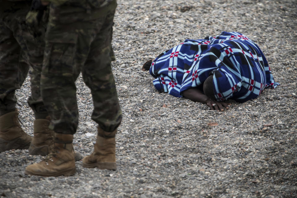 A man lying on the ground after arriving in the Spanish territory at the border of Morocco and Spain, at the Spanish enclave of Ceuta, on Tuesday, May 18, 2021. Ceuta, a Spanish city of 85,000 in northern Africa, faces a humanitarian crisis after thousands of Moroccans took advantage of relaxed border control in their country to swim or paddle in inflatable boats into European soil. Around 6,000 people had crossed by Tuesday morning since the first arrivals began in the early hours of Monday, including 1,500 who are presumed to be teenagers. (AP Photo/Javier Fergo)