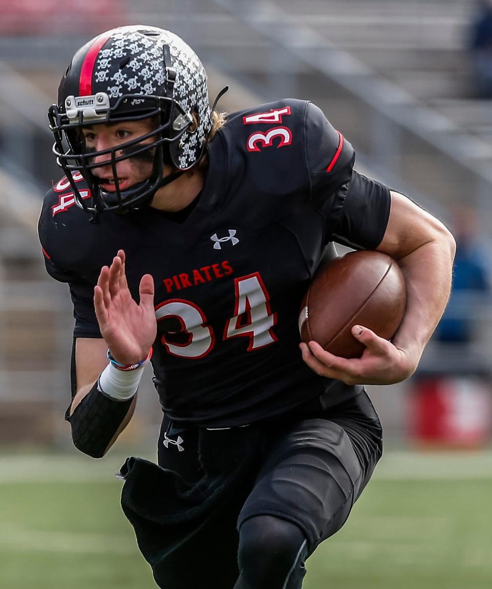 Pewaukee quarterback Carson Hansen (34) runs from the pocket during the WIAA Division 3 state championship football game against Rice Lake at Camp Randall Stadium in Madison on Friday, Nov. 19, 2021.