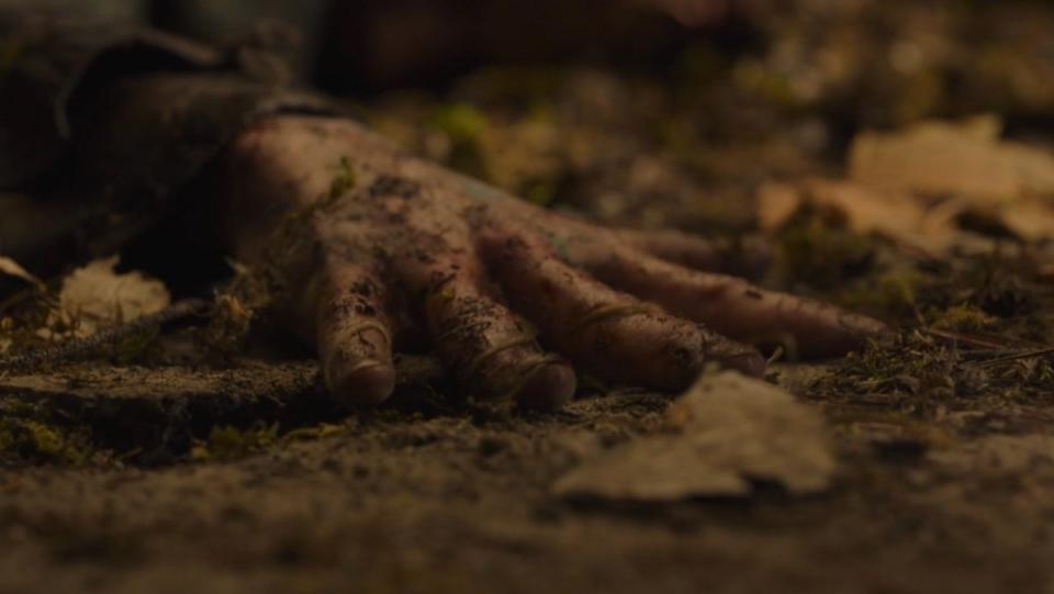 A zombie hand is alerted by fungus on The Last of Us