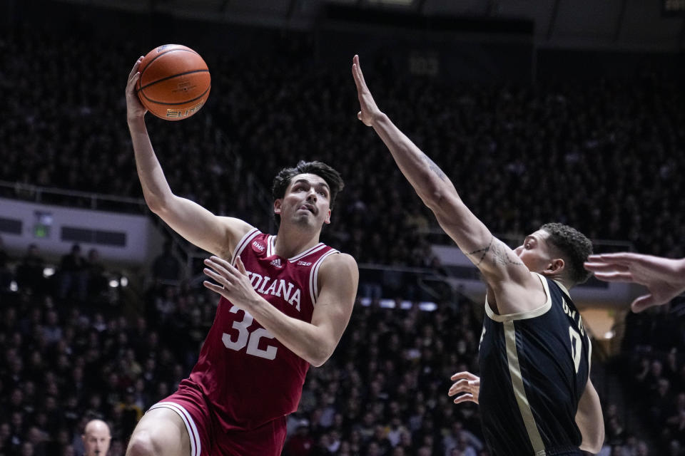 Indiana guard Trey Galloway (32) shoots over Purdue forward Mason Gillis (0) during the first half of an NCAA college basketball game in West Lafayette, Ind., Saturday, Feb. 10, 2024. (AP Photo/Michael Conroy)