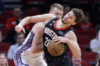 Houston Rockets center Alperen Sengun, right, tries to drive around Sacramento Kings forward Domantas Sabonis, left, during the first half of an NBA basketball game Monday, Feb. 6, 2023, in Houston. (AP Photo/Michael Wyke)